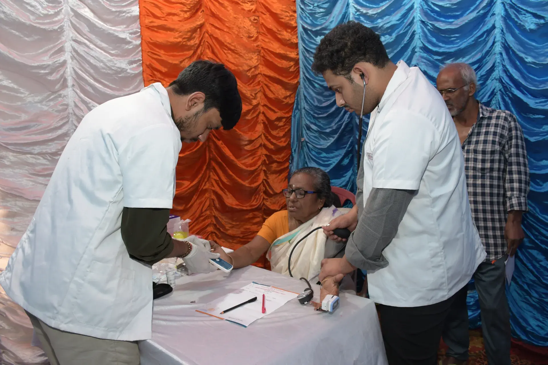 Residents receiving free health checkups at the health camp in Baranagar