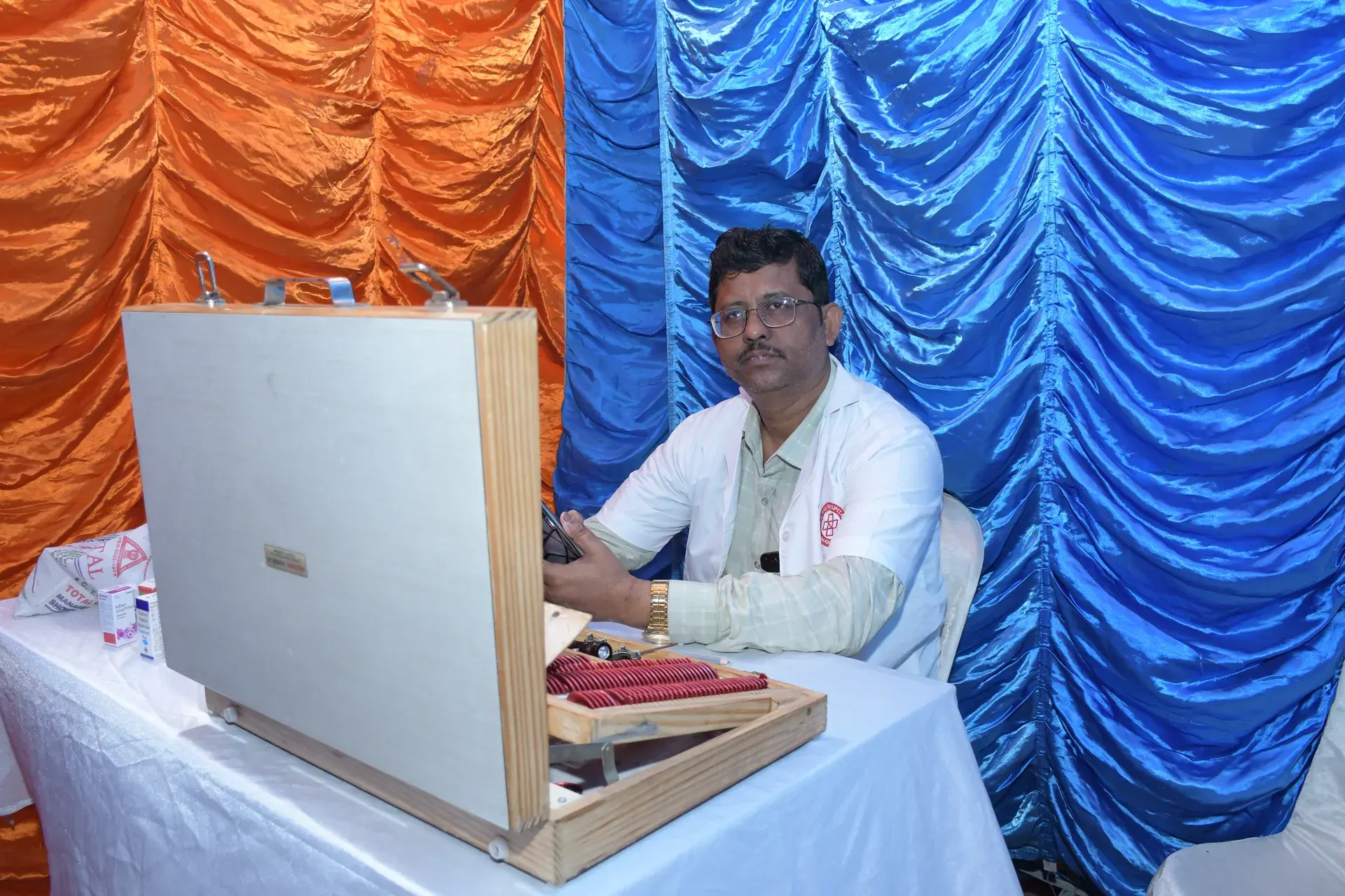 A doctor performing a free eye checkup for a resident at the camp